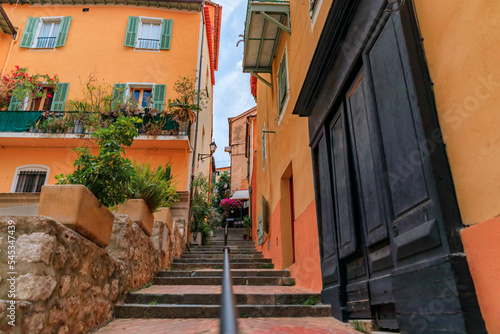 Traditional old terracotta houses on a narrow street in the Old Town of Villefranche sur Mer on the French Riviera, South of France