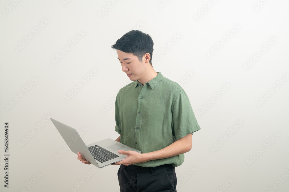 young Asian man using laptop on hand young Asian man using laptop on hand