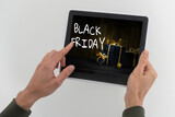 man using tablet pc and selecting black friday.
