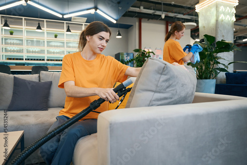 Valokuva Cleaners cleaning company perform a thorough cleaning of the furniture