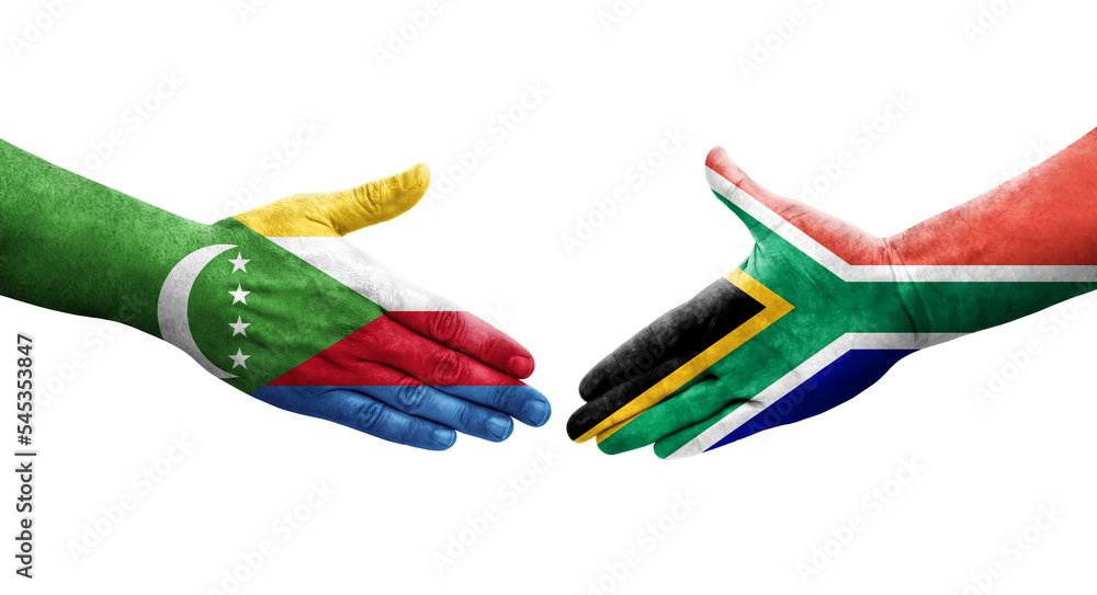 Handshake between South Africa and Comoros flags painted on hands, isolated transparent image. Handshake between South Africa and Comoros flags painted on hands, isolated transparent image.