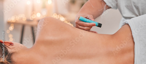 Spa, heat acupuncture and woman relaxing for a back massage using moxibustion or alternative medicine. Healing, acupuncturist and massage therapy with physical therapy on patient with sen treatment photo