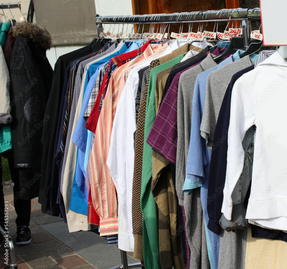vintage used and new clothes for sale in the stall stand at the flea market