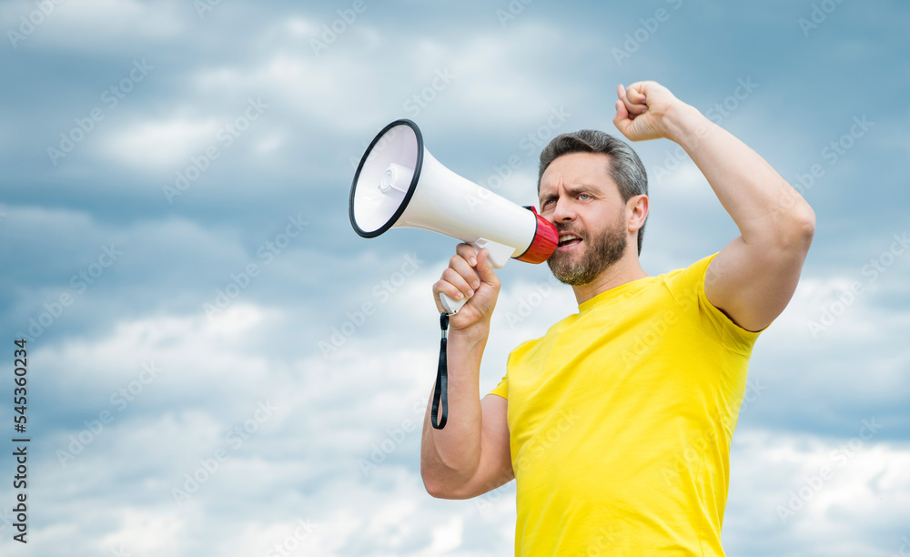man in yellow shirt proclaim in loudspeaker on sky background man in yellow shirt proclaim in loudspeaker on sky background