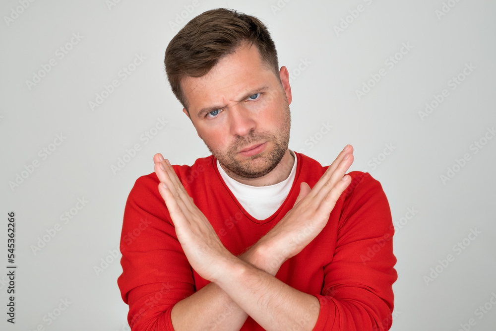 Mature man looking serious showing open palm making stop gesture Mature man looking serious showing open palm making stop gesture