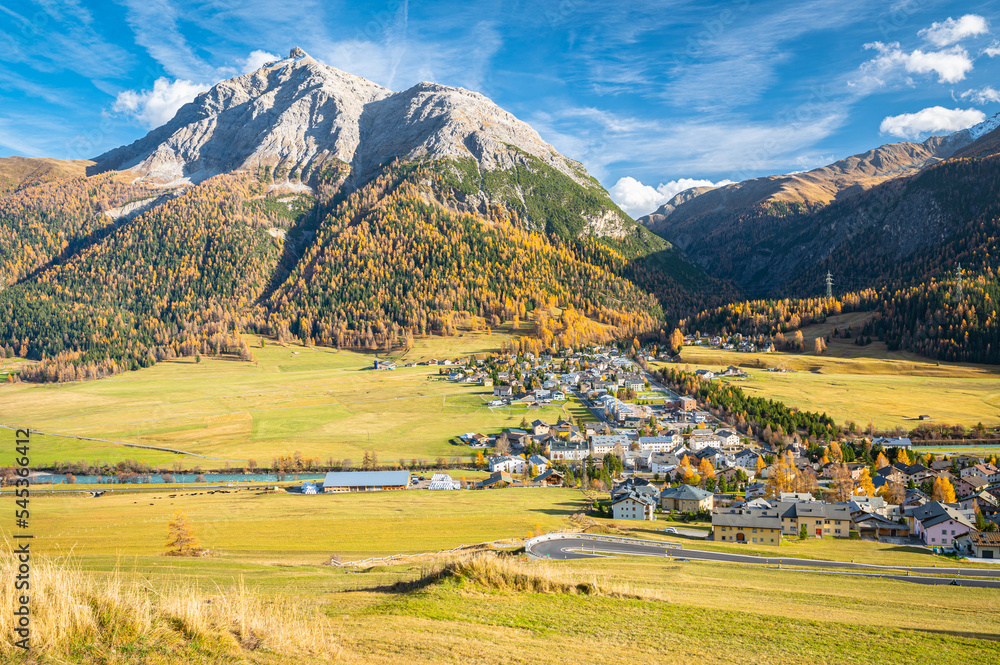 Scenic view of the village of La Punt Chamues-ch in Engadin valley, Switzerland on a sunny day in autumn