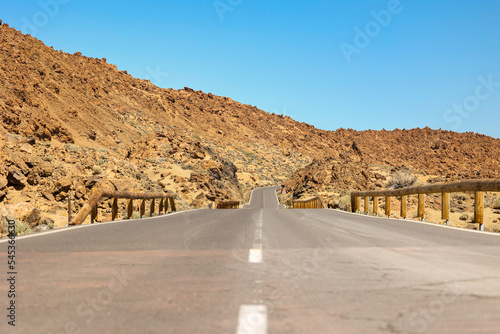 The road that seems to disappear as it winds to the top of Mount Teide, located in Tenerife, Spain. The dry heat shows a small mirage at the dip in the road. 