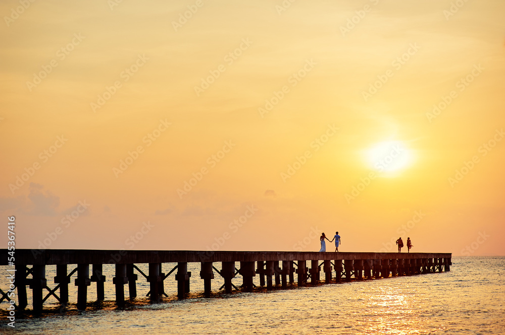 Pier on the sea shore at sunset time.