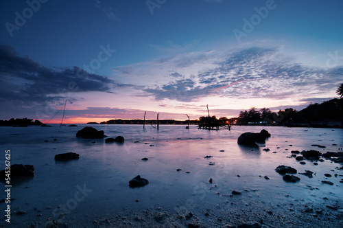 Fototapeta Naklejka Na Ścianę i Meble -  Beautiful seascape with colorful sky. Sunset and night time on the rock beach.