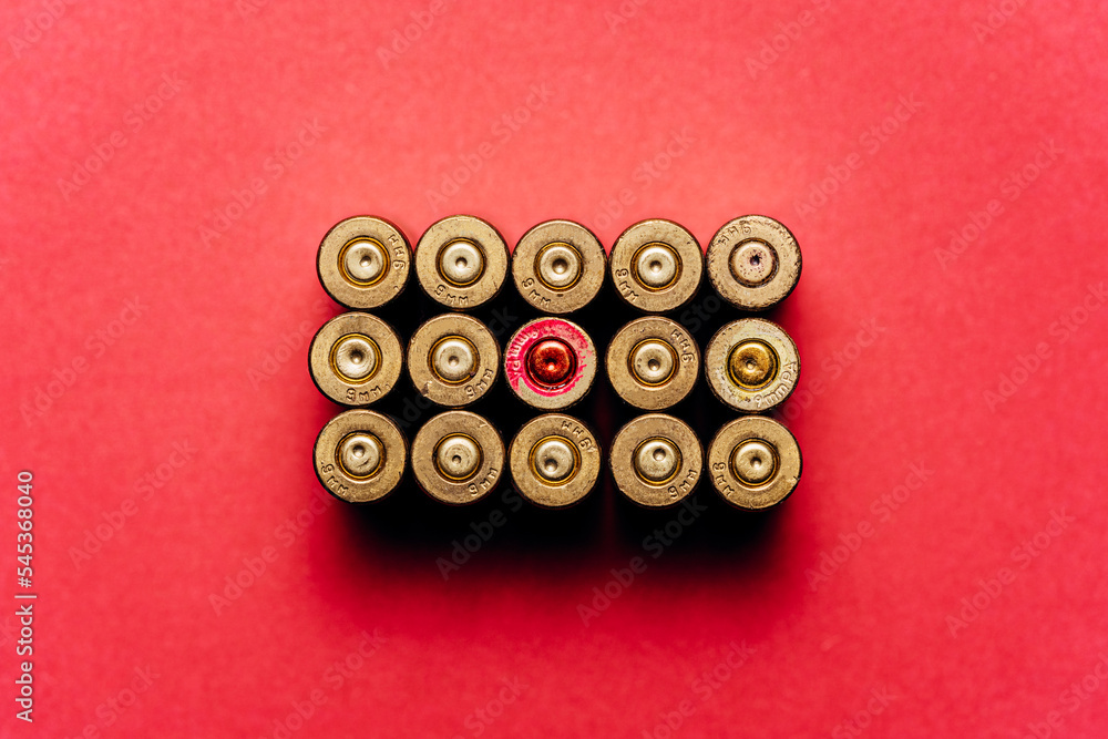 Small caliber cartridges on a red background. Small caliber cartridges on a red background.