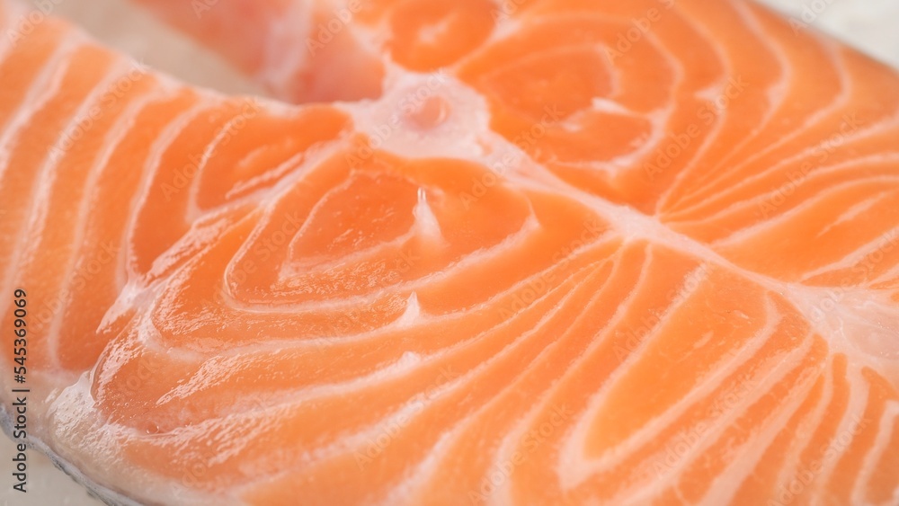 Raw, fresh salmon steak on ice cubes. Buy fish in the market or in the store Raw, fresh salmon steak on ice cubes. Buy fish in the market or in the store