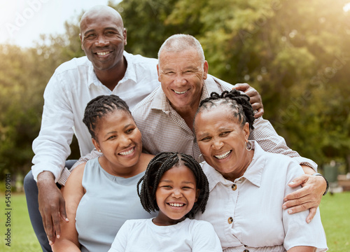 Happy black family, hug and portrait smile for quality bonding happiness together for outdoor fun in nature. Mother, father and grandparents with kid smiling for family vacation or holiday at a park
