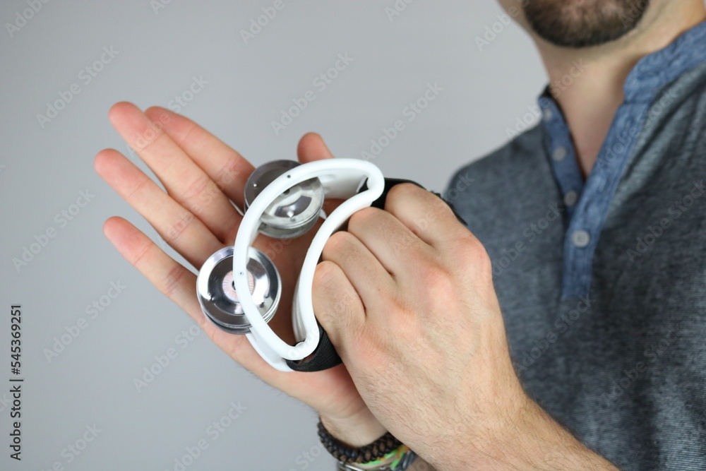 Fototapeta premium Young man playing white mini tambourine 