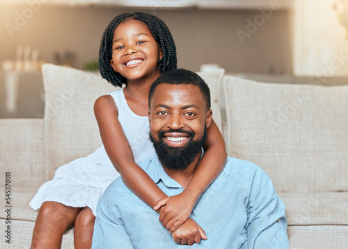 Love, black man father and girl hug, smile and in living room on sofa, with happiness and loving together. Portrait, African American dad and daughter embrace, happy and bonding in lounge on couch.