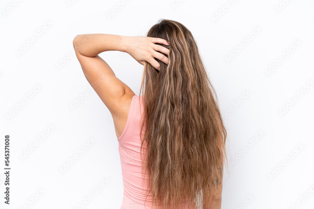 Young caucasian woman isolated on white background in back position and thinking Young caucasian woman isolated on white background in back position and thinking