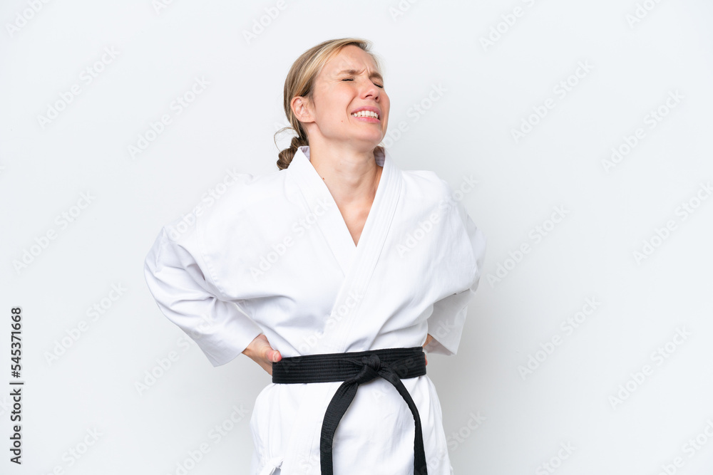 Young caucasian woman doing karate isolated on white background suffering from backache for having made an effort Young caucasian woman doing karate isolated on white background suffering from backache for having made an effort