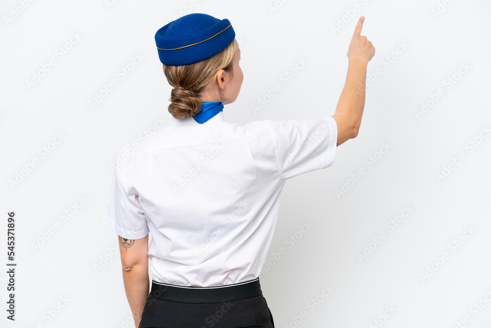 Airplane blonde stewardess woman isolated on white background pointing back with the index finger