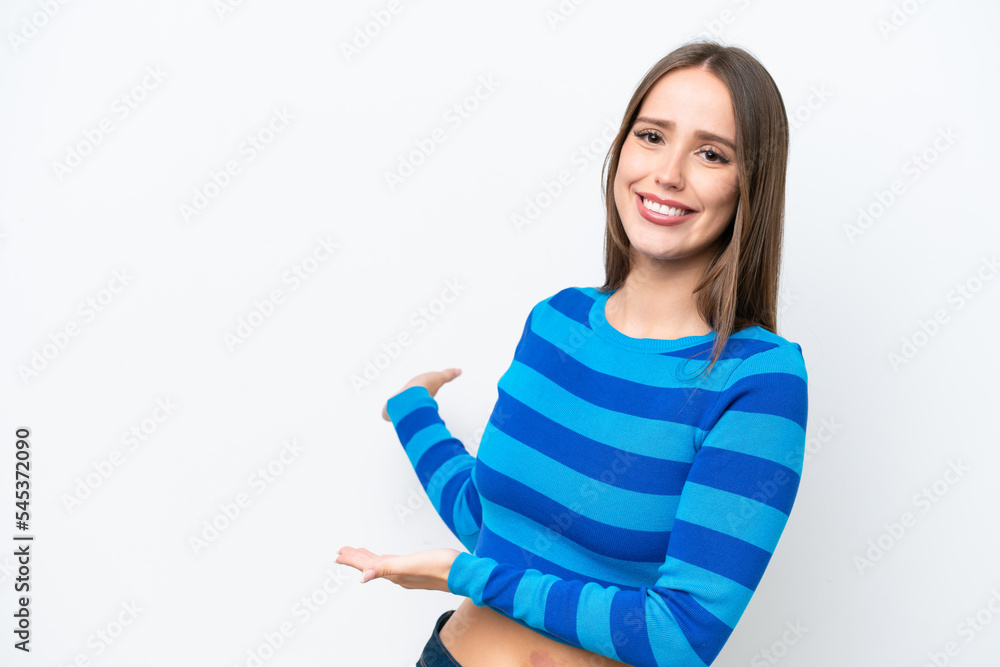 Young pretty caucasian woman isolated on white background extending hands to the side for inviting to come Young pretty caucasian woman isolated on white background extending hands to the side for inviting to come