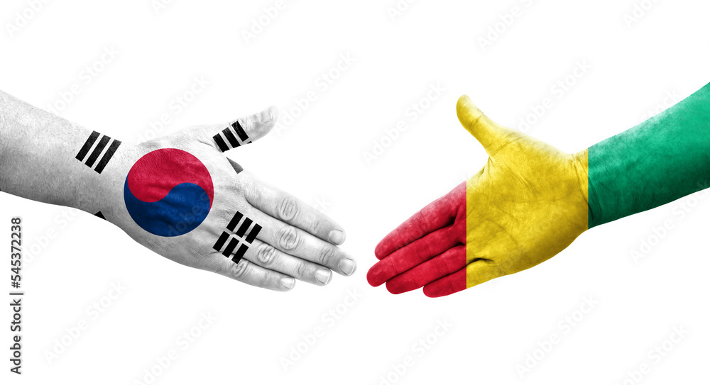 Handshake between South Korea and Guinea flags painted on hands, isolated transparent image.
