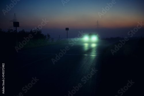 car on the night road, car headlights, foggy road