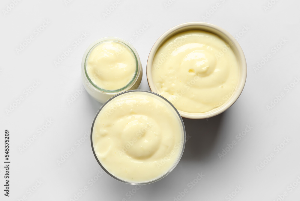 Dishes of tasty pudding on grey background Dishes of tasty pudding on grey background