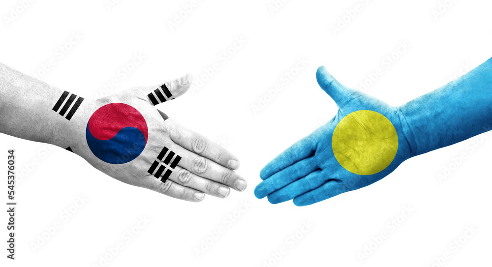 Handshake between South Korea and Palau flags painted on hands, isolated transparent image. Handshake between South Korea and Palau flags painted on hands, isolated transparent image.