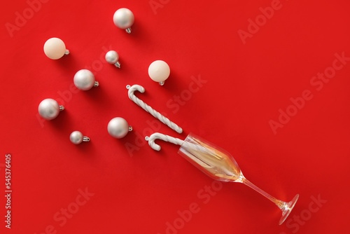 Valokuva Composition with glass and Christmas decorations on red background