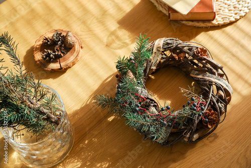 Christmas wreath on wooden table, closeup