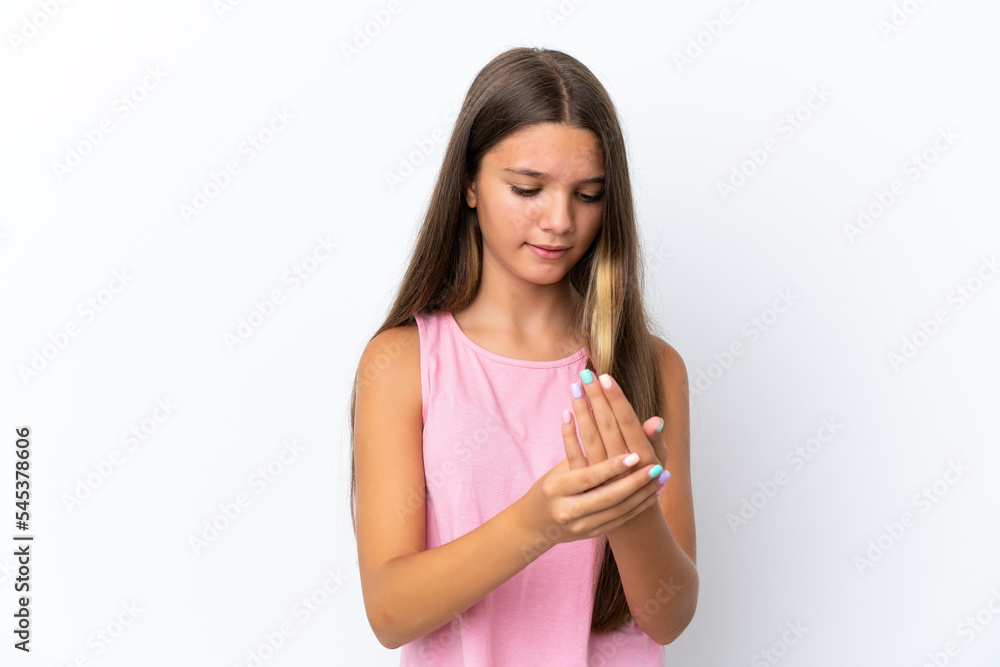 Little caucasian girl isolated on white background suffering from pain in hands Little caucasian girl isolated on white background suffering from pain in hands