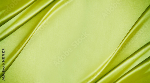 Obraz na płótnie Yellow green silk satin. Lime color shiny silky smooth fabric. Soft wavy folds. Elegant background with space for design. Bright. Light. Banner. Flat lay, top view table. Template. w salonie
