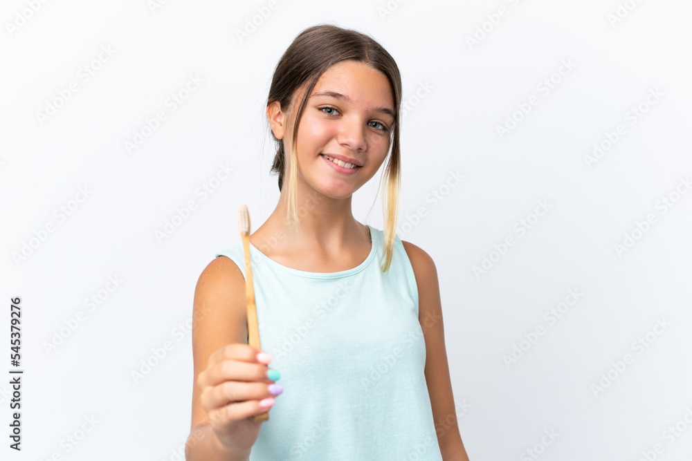 Little caucasian girl holding a toothbrush isolated on white background with happy expression Little caucasian girl holding a toothbrush isolated on white background with happy expression