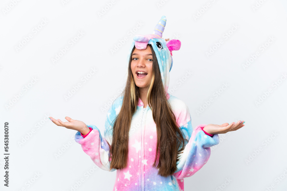 Little caucasian girl wearing unicorn pajama isolated on white background with shocked facial expression Little caucasian girl wearing unicorn pajama isolated on white background with shocked facial expression