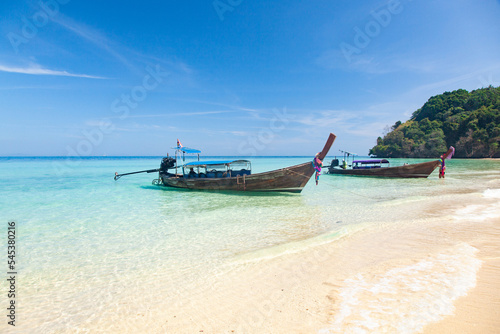 beautiful tropical beach in Thailand with longtail boats