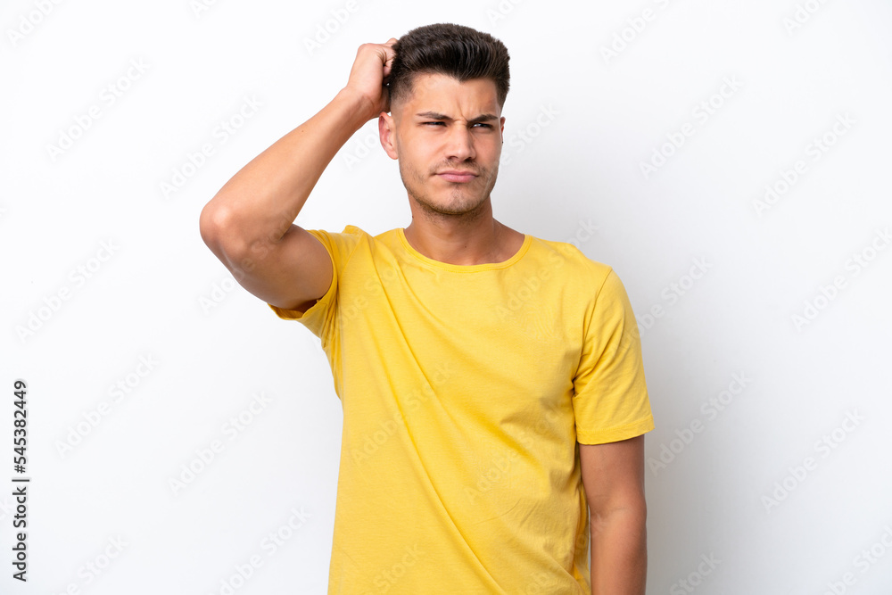 Young caucasian man isolated on white background having doubts while scratching head Young caucasian man isolated on white background having doubts while scratching head