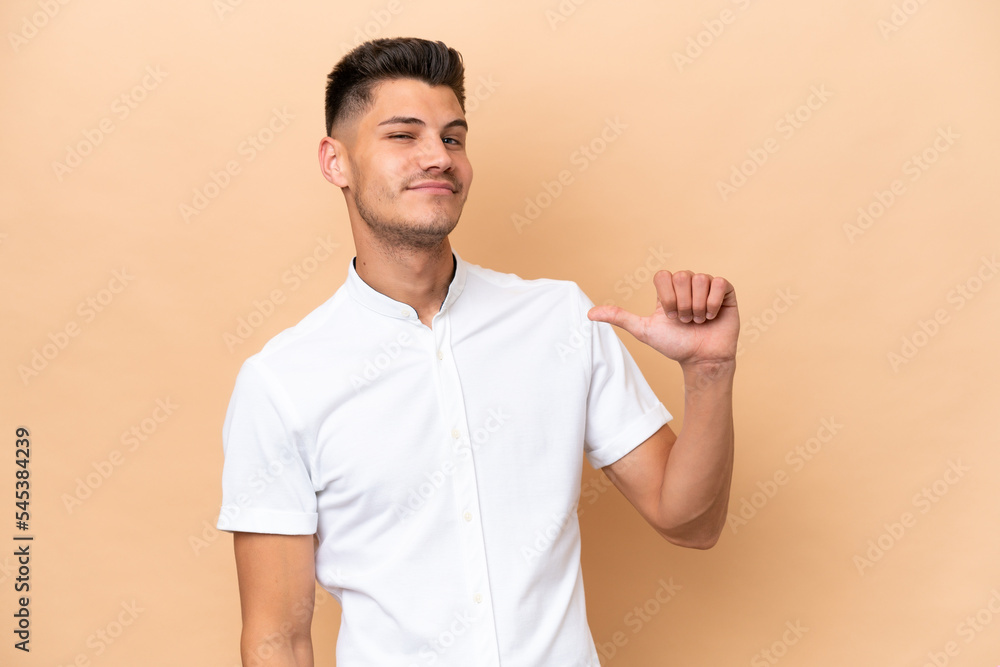 Young caucasian man isolated on beige background proud and self-satisfied Young caucasian man isolated on beige background proud and self-satisfied
