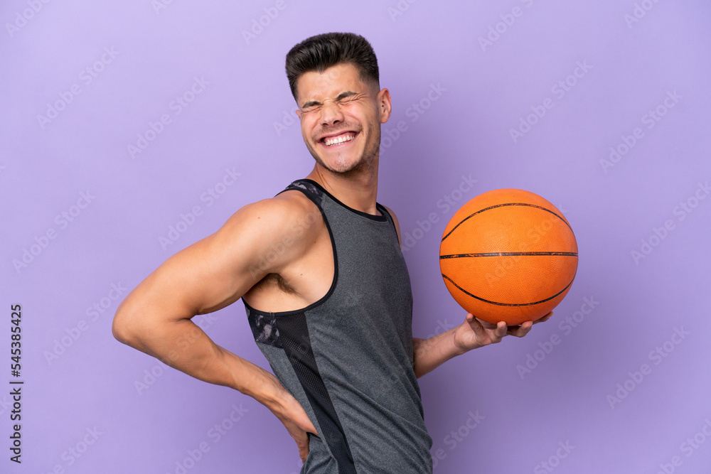 young caucasian woman  basketball player man isolated on purple background suffering from backache for having made an effort