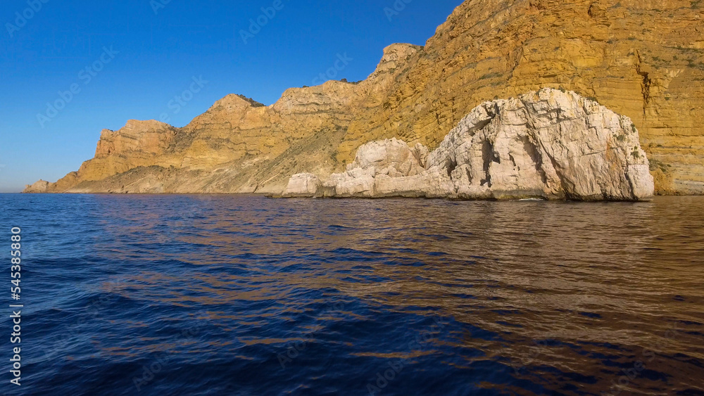 Sierra Helada cliffs and Mitjana island from the sea, Benidorm, Alicante province, Spain