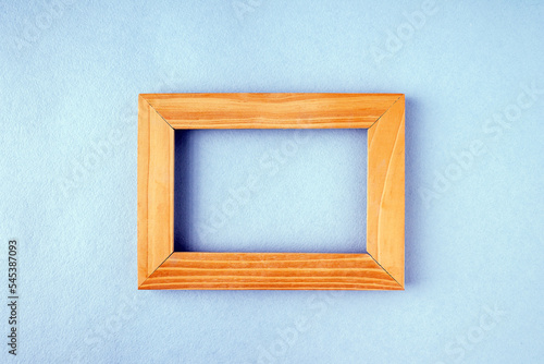 wooden frame on blue background, copy space, mockup