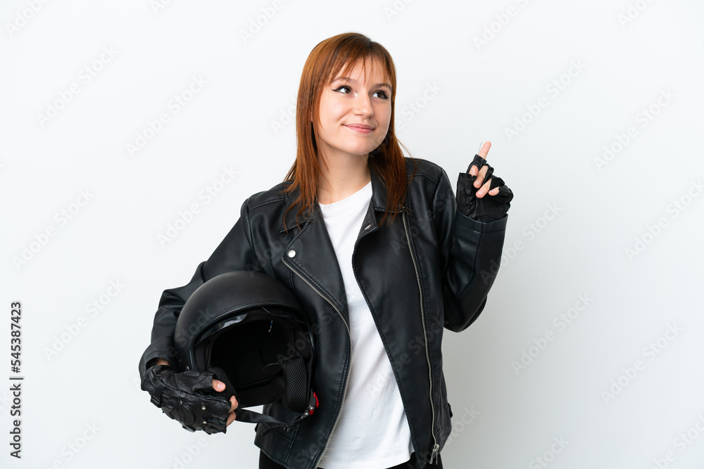 Redhead girl with a motorcycle helmet isolated on white background pointing up a great idea Redhead girl with a motorcycle helmet isolated on white background pointing up a great idea