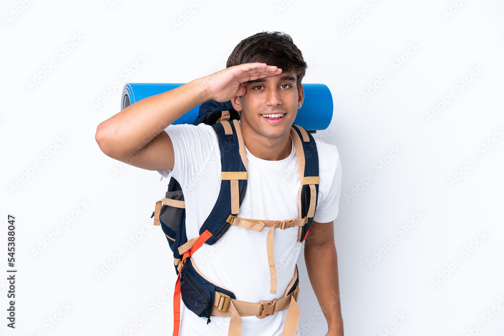 Young mountaineer woman with a big backpack over isolated white background looking far away with hand to look something Young mountaineer woman with a big backpack over isolated white background looking far away with hand to look something