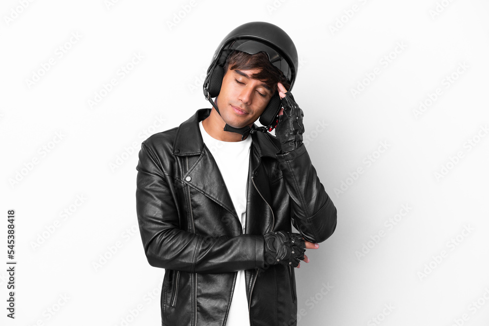 Young man with a motorcycle helmet isolated on white background with headache Young man with a motorcycle helmet isolated on white background with headache