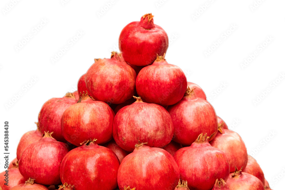 Pomegranate fruits isolated on white background. Red tropical fruit. Stack of fresh pomegranates Pomegranate fruits isolated on white background. Red tropical fruit. Stack of fresh pomegranates