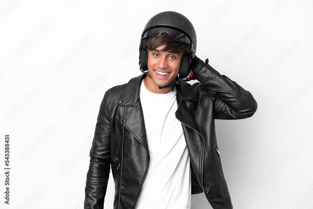 Young man with a motorcycle helmet isolated on white background laughing Young man with a motorcycle helmet isolated on white background laughing