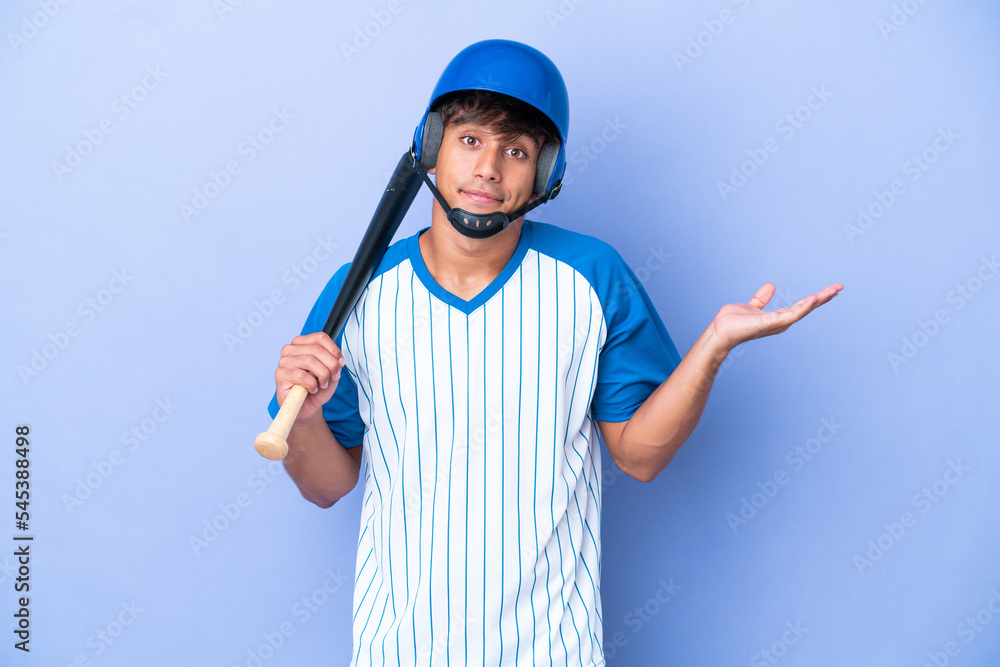 Baseball caucasian man player with helmet and bat isolated on blue background having doubts while raising hands Baseball caucasian man player with helmet and bat isolated on blue background having doubts while raising hands