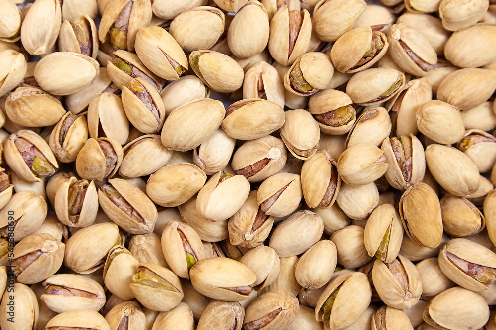 Pistachios texture and background. Pistachio nuts, top view, flat lay Pistachios texture and background. Pistachio nuts, top view, flat lay