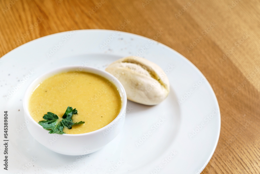 pumpkin cream soup on wooden table pumpkin cream soup on wooden table
