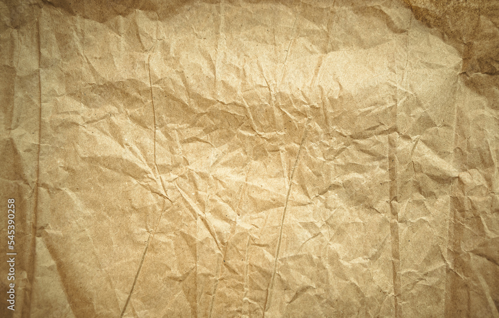Fototapeta premium Crumpled texture of craft paper.The background is made of yellowed old packaging paper.