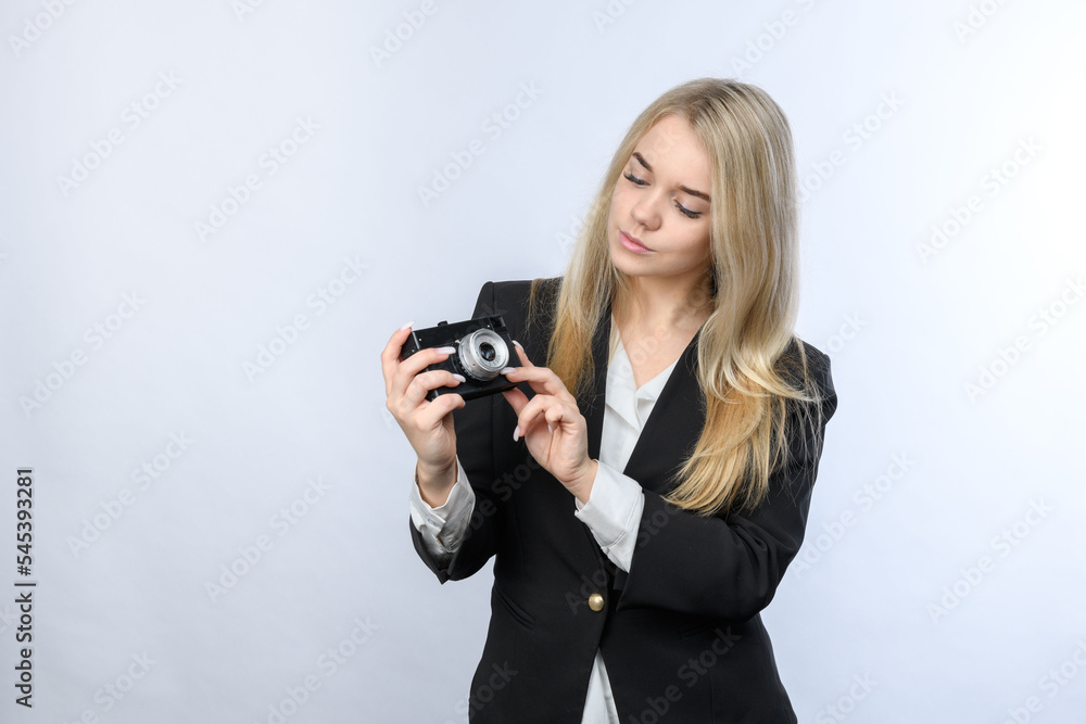 Young beautiful blonde woman holding retro camera on white background. Young beautiful blonde woman holding retro camera on white background.