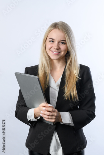 Portrait of young beautiful blonde businesswoman smiling with laptop on white background
