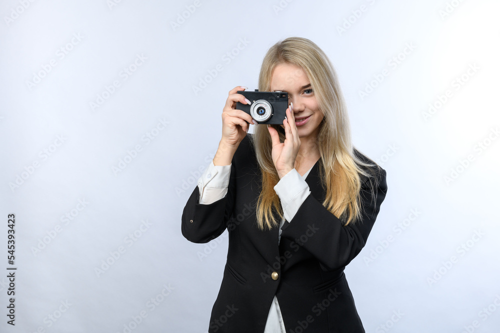 Young beautiful blonde woman holding old film camera on white background. Young beautiful blonde woman holding old film camera on white background.